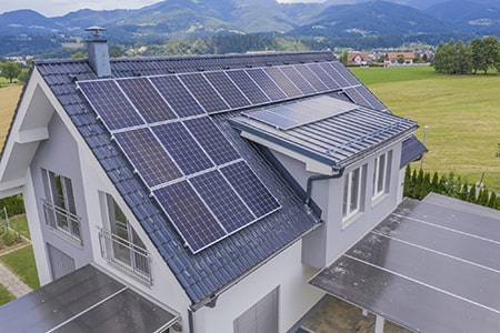aerial view private house with solar panels roof 2048x1364 min